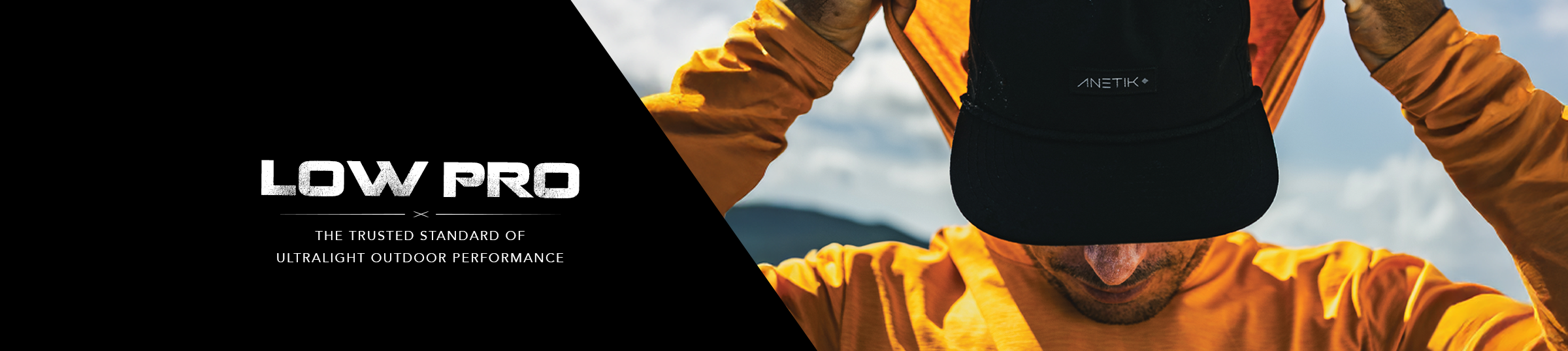 Anetik Low Pro performance hoodie featuring athlete pulling up hood with focus on ultralight fabric and sun protection design