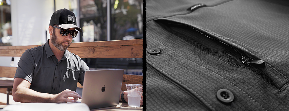 man wearing Anetik's technician shirt working on laptop